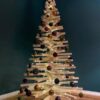 Alternativer geschmückter Holzweihnachtsbaum aus Fichtenholz mit Lichterkette und braunen Kugeln